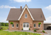 Frontalansicht eines Kapitänshaus mit Flachdachziegel J11v in dunkelbraunbuchholz.de)