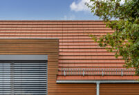 Parcelhus med træelementer og WALTHER Stylist flade tegl i rødbrun på taget