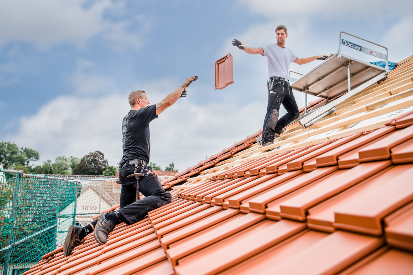 Roofer covering a roof